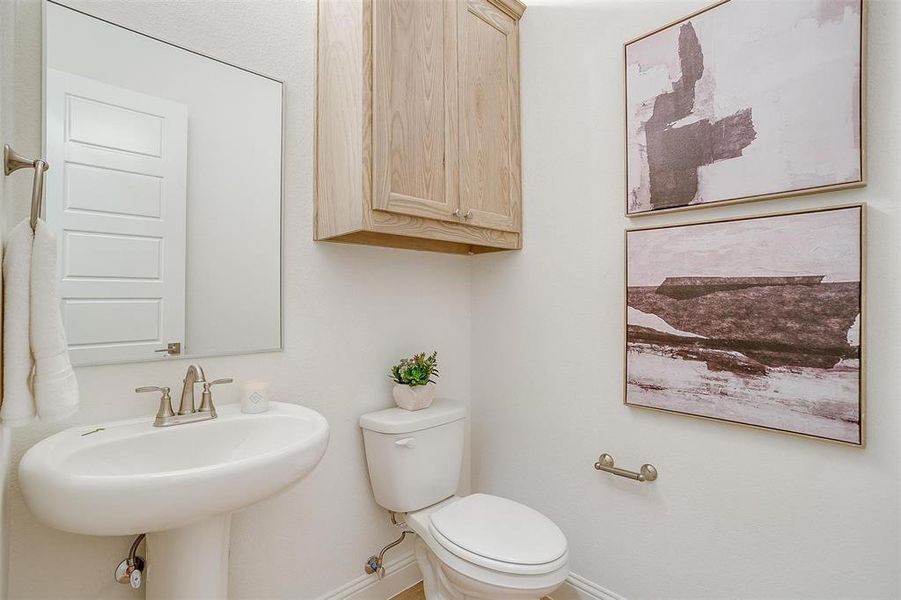 Powder bath with cabinet and pedestal sink