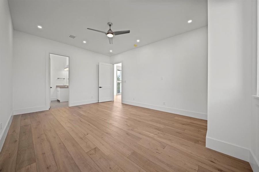 Bedroom 4 offers a spacious and inviting retreat with beautiful wood flooring, recessed lighting, and a modern ceiling fan for added comfort. The room features a private ensuite bathroom and ample natural light, making it perfect for guests or family members seeking their own sanctuary. Its clean and contemporary design allows for endless decorating possibilities