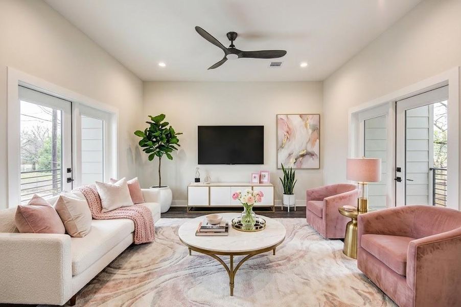 Bright and inviting living room with large patio doors leading to two balconies on both sides.