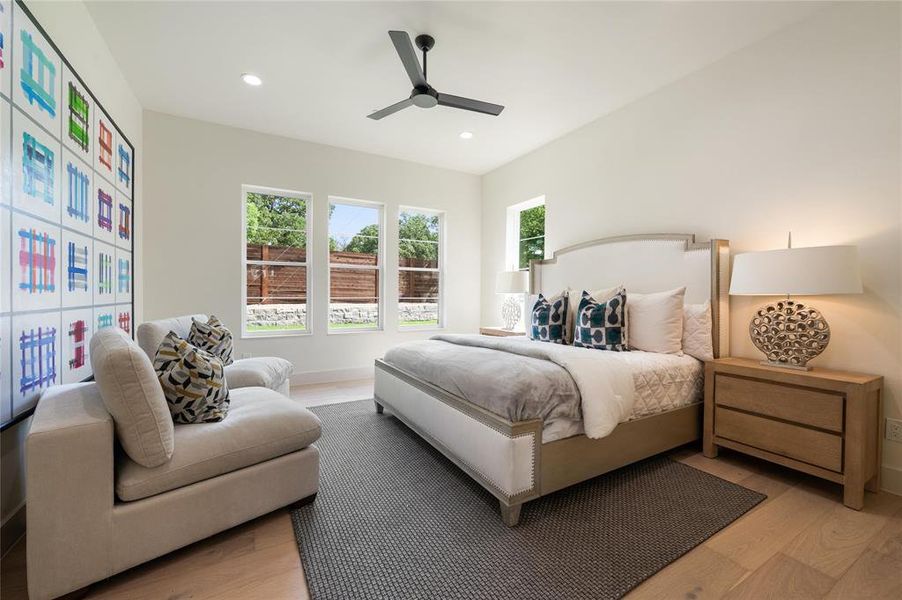 Bedroom with light hardwood / wood-style flooring and ceiling fan