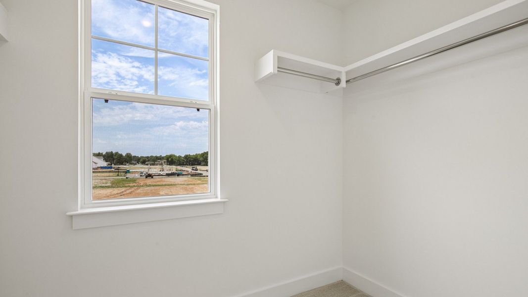 Primary closet with built-in shelf Primary closet with built-in shelf