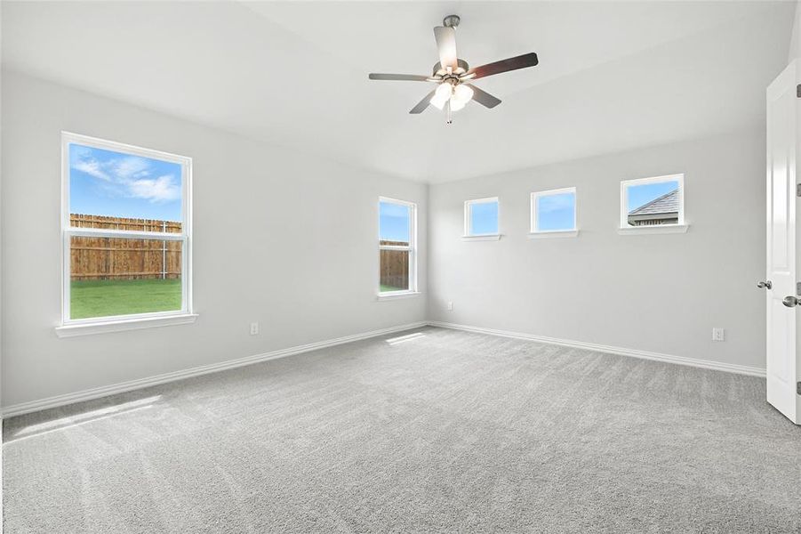 Empty room featuring carpet and a ceiling fan