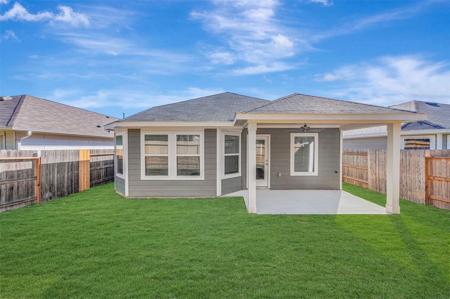 Exterior details and patio area of a home in Pinewood at Grand Texas, New Caney (Image 28).