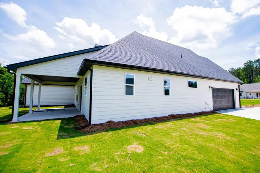 Exterior details and patio area of a home in WOODMONT RESERVE, Roopville (Image 51).