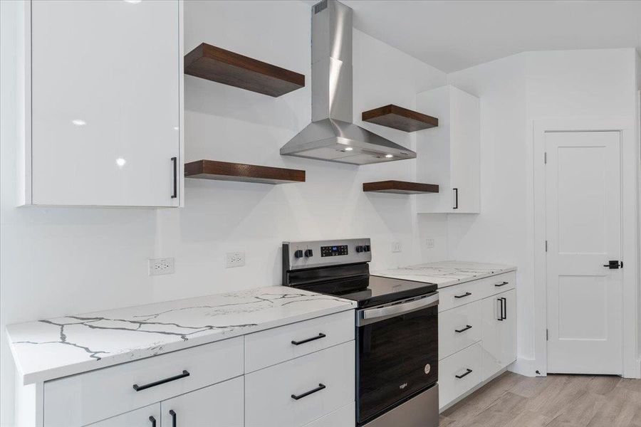 Kitchen featuring open shelves, wall chimney exhaust hood, electric stove, white cabinets, and light wood-style floors Kitchen featuring open shelves, wall chimney exhaust hood, electric stove, white cabinets, and light wood-style floors