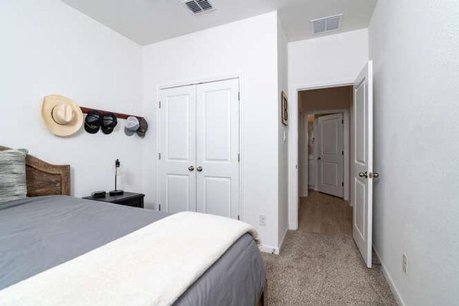 Bedroom featuring carpet floors and a closet