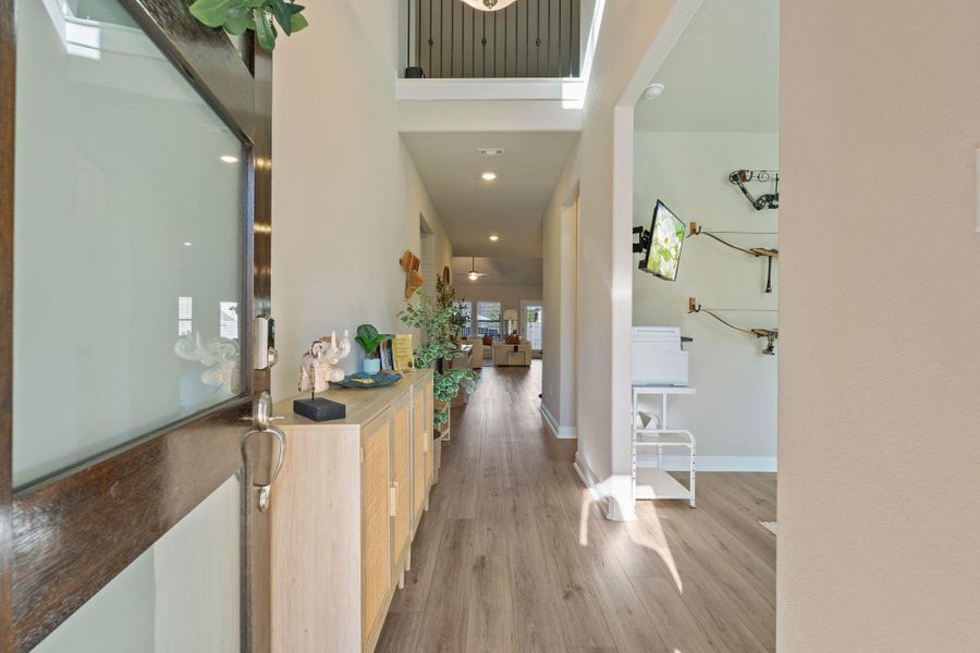Bright and welcoming entryway with light wood flooring, leads to an open living space, offering a cozy, well-lit area perfect for relaxation. Bright and welcoming entryway with light wood flooring, leads to an open living space, offering a cozy, well-lit area perfect for relaxation.