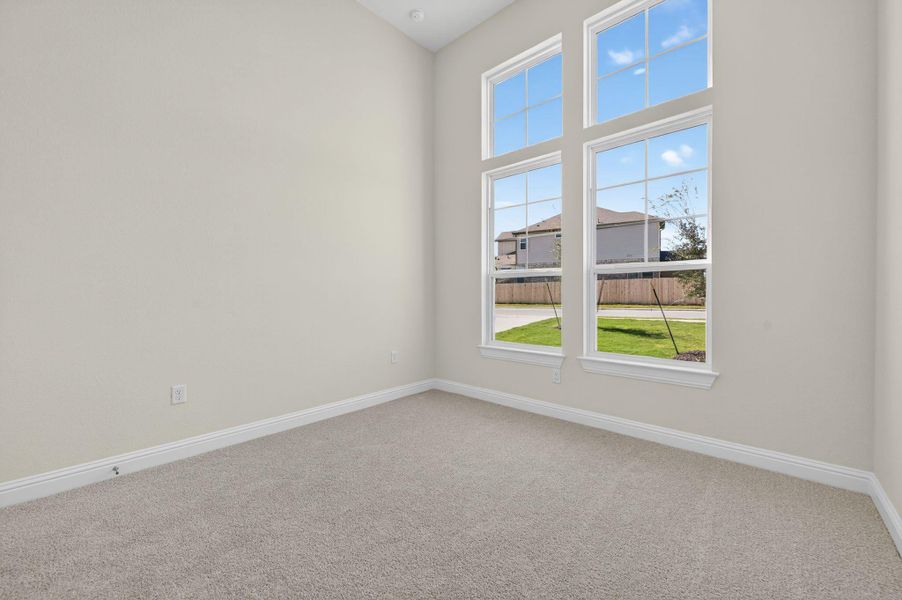 Spare room with light carpet and baseboards