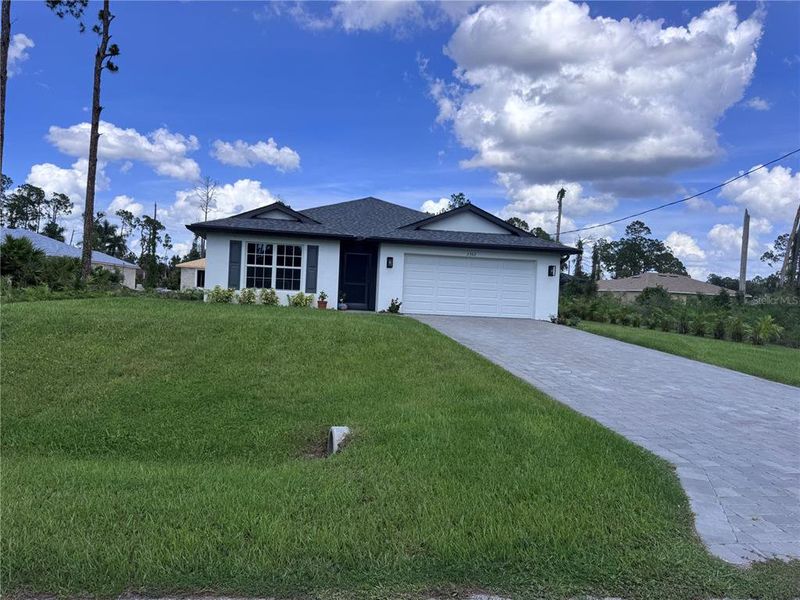 Front exterior of a new home in , North Port, FL, highlighting curb appeal (Image 1). Front exterior of a new home in , North Port, FL, highlighting curb appeal (Image 1).