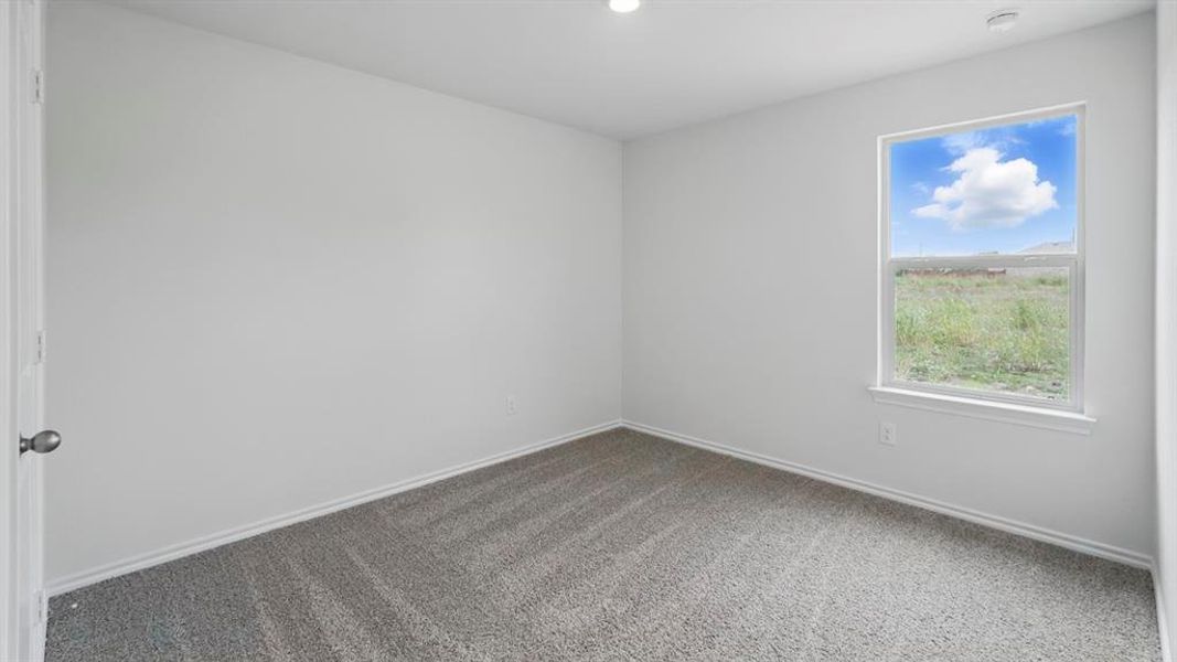 Room featuring light gray walls, gray carpeting, white trim, a single window, and a recessed ceiling light