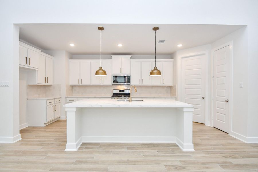 A closer look at the gourmet kitchen with sleek appliances and a functional design perfect for entertaining.