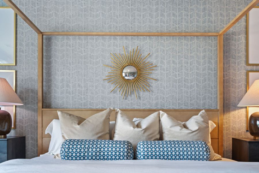 A bed with a fan on it. A bed with a fan on it.