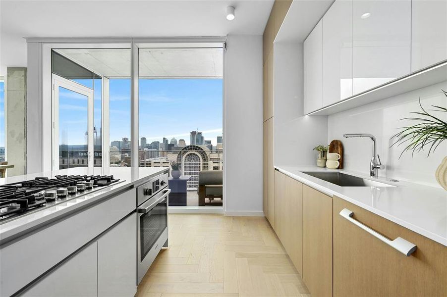 Sleek cabinets provide ample storage space while maintaining a clean and minimalist aesthetic. The kitchen's design is further enhanced by high-quality materials and finishes, elevating the overall ambiance. *Linden Residence No. 2107 Furnished Model Shown Here