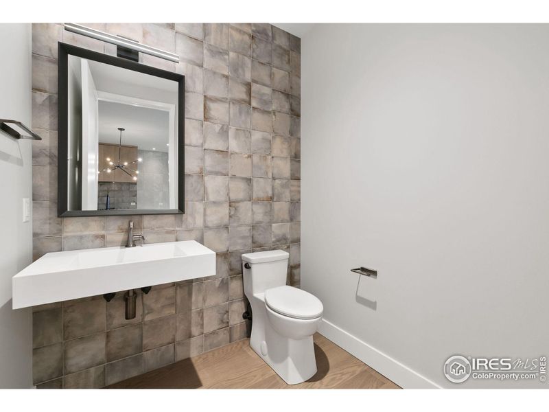 Modern half-bath with feature wall.