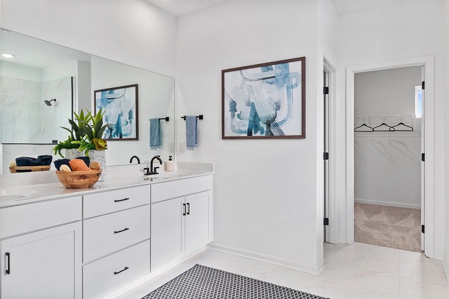 A bathroom with a sink and a mirror.