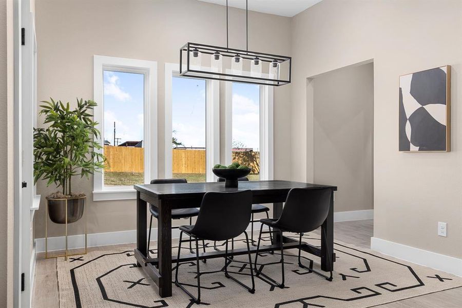 Dining space with light hardwood / wood-style floors