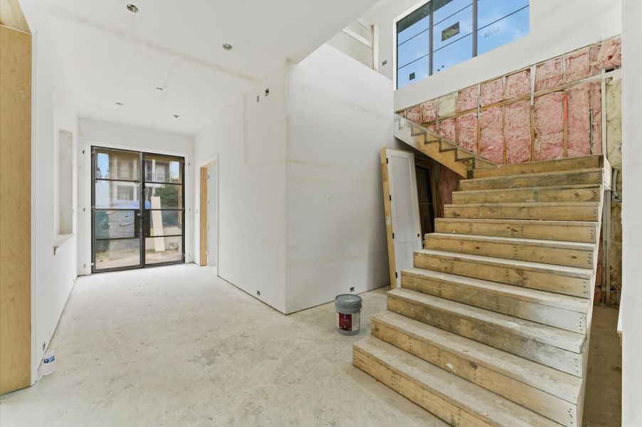 The floating staircase off the foyer leads to the second floor.