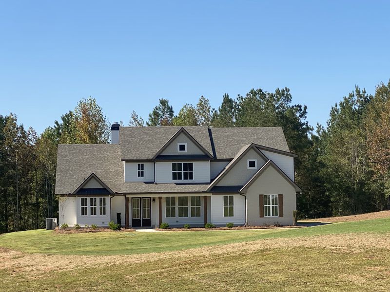 Front exterior of a new home in Harmon Springs, Carrollton, GA, highlighting curb appeal (Image 1).