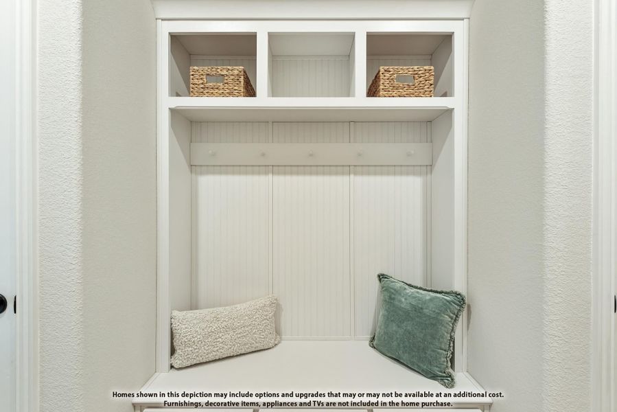 Mudroom cubby with white beadboard, built-in bench, coat hooks, and upper shelves with wicker storage baskets Mudroom cubby with white beadboard, built-in bench, coat hooks, and upper shelves with wicker storage baskets