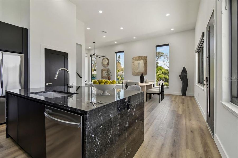 Virtually Staged - Kitchen view to Dining and Living Room