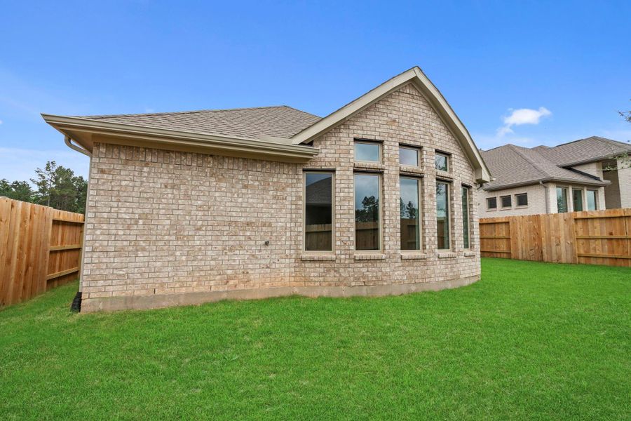 Exterior details and patio area of a home in Wildtree, Magnolia (Image 23).