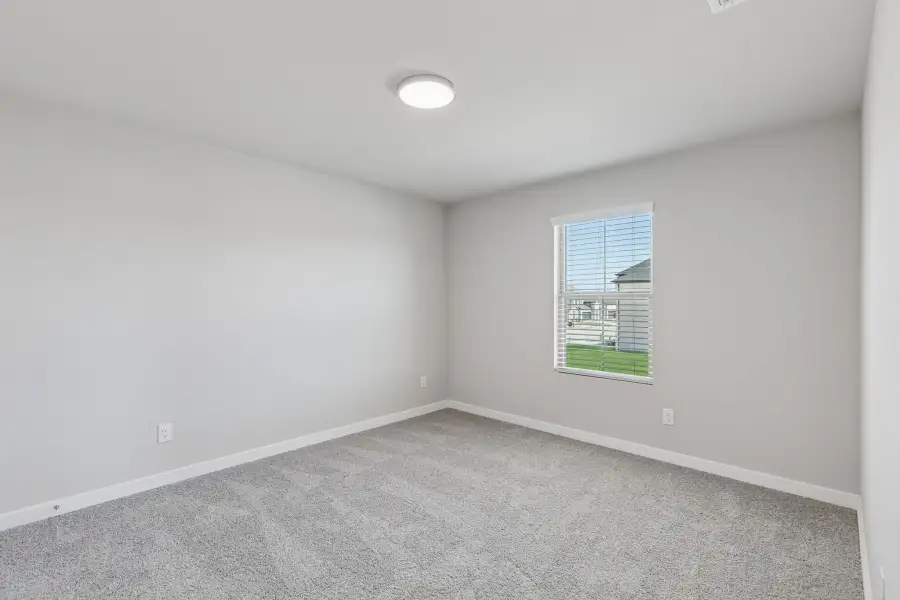 Bedroom in the Holden home plan by Trophy Signature Homes – REPRESENTATIVE PHOTO