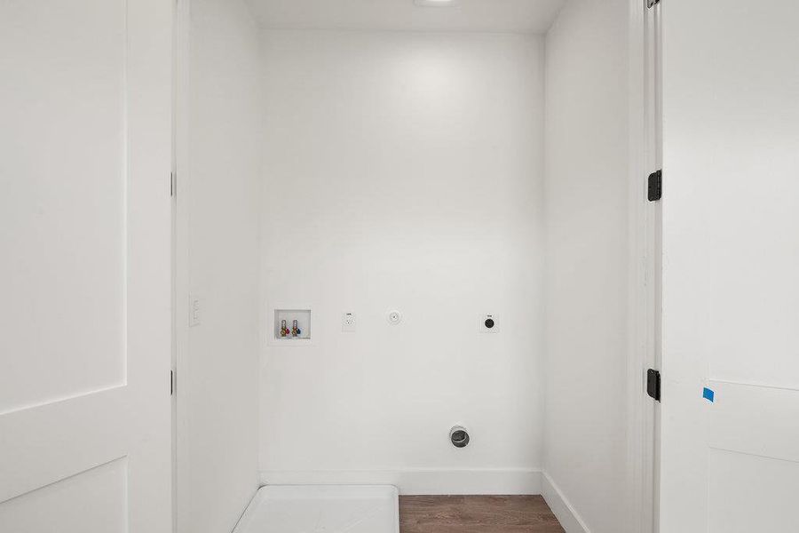 Washroom featuring hookup for a washing machine, dark wood finished floors, electric dryer hookup, and gas dryer hookup