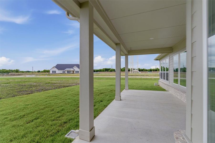 Covered patio with a concrete surface and architectural columns