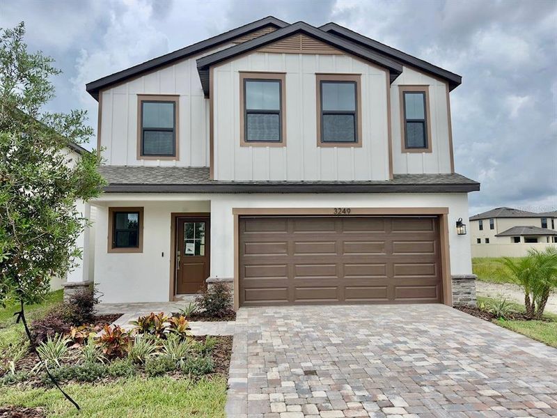 Front exterior of a new home in Grasslands West, Lakeland, FL, highlighting curb appeal (Image 22).