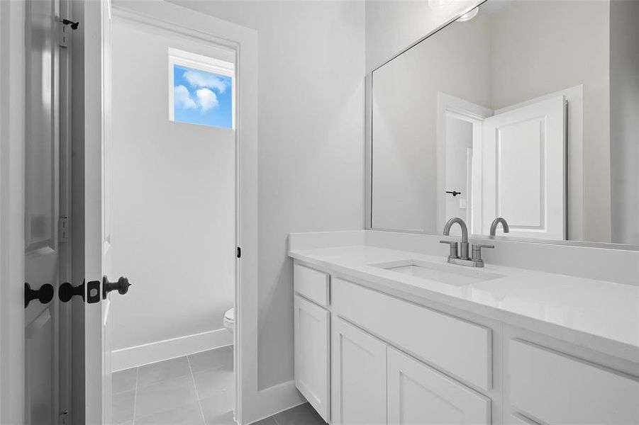Bathroom with vanity and light tile patterned flooring