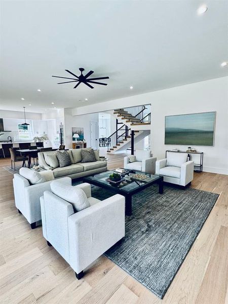 Living room featuring ceiling fan and light wood-type flooring