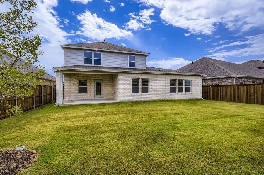 A house with a fence and grass.