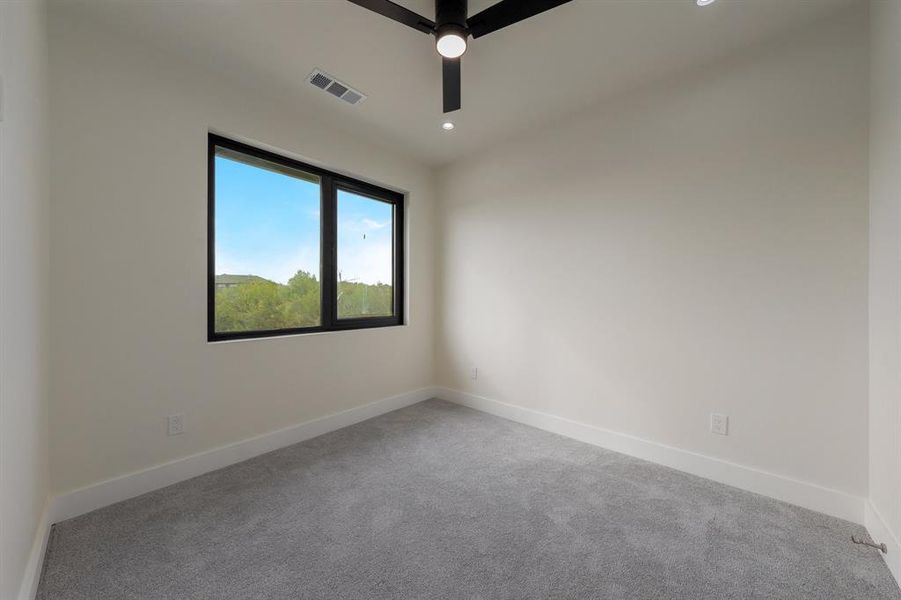 Bedroom 4, featuring a ceiling fan and recessed lighting
