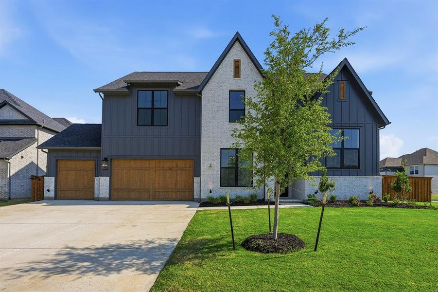 Front exterior of a new home in Light Farms Graham/Reagan, Celina, TX, highlighting curb appeal (Image 24).