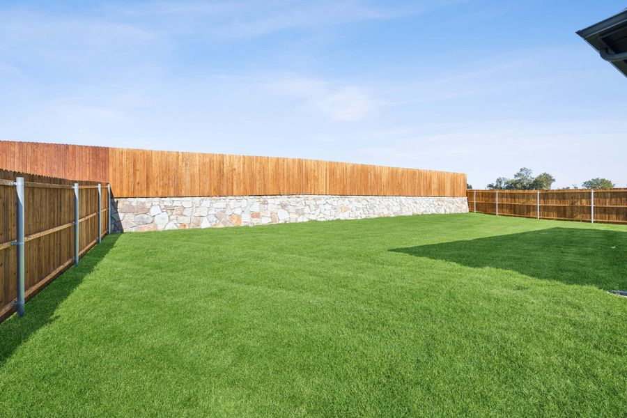 Back Yard in a Belmont Magnolia Model Home in Aubrey TX by Trophy Signature Homes
