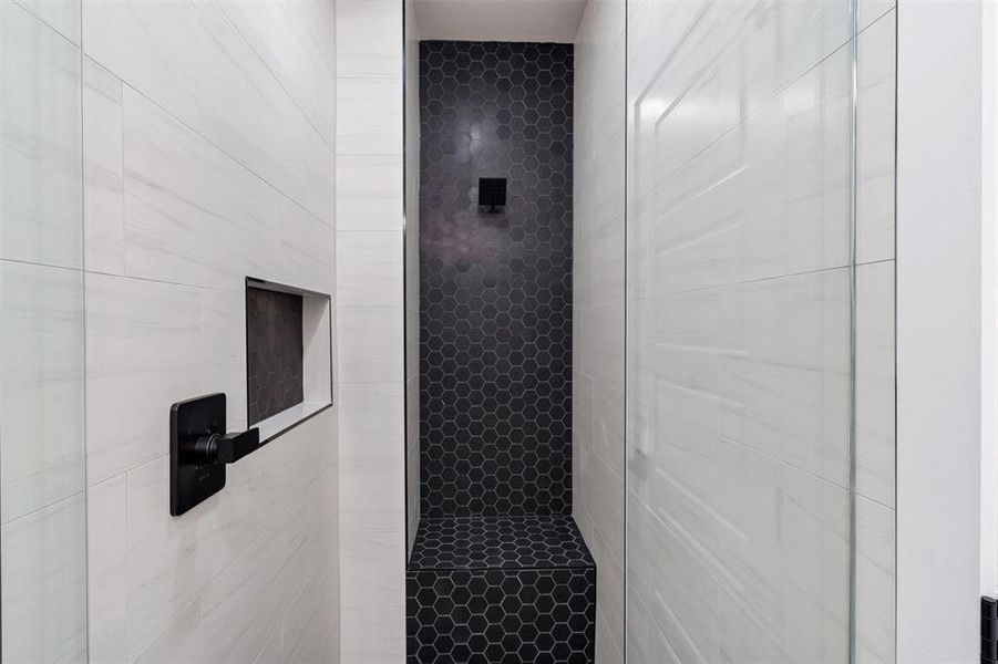 Bathroom featuring a tile shower