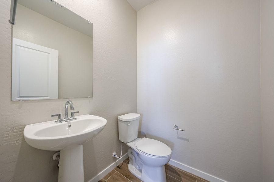 A bathroom with a toilet and sink.