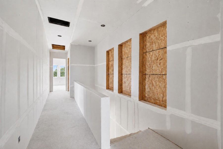 This part of the hallway leads to the laundry room and secondary bedrooms. This part of the hallway leads to the laundry room and secondary bedrooms.