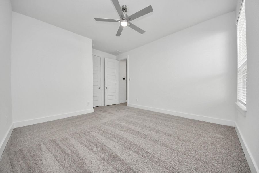 Generously sized secondary bedrooms featuring spacious closets, soft and inviting carpeting underfoot, large windows allowing plenty of natural light, and the added touch of privacy blinds for your personal retreat.