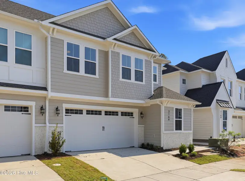 Front exterior of a new home in East & Mason, Wilmington, NC, highlighting curb appeal (Image 2). Front exterior of a new home in East & Mason, Wilmington, NC, highlighting curb appeal (Image 2).