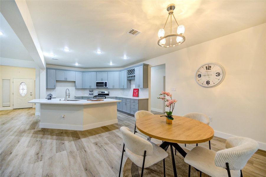 Bright and inviting dining space, seamlessly connected to a modern kitchen.