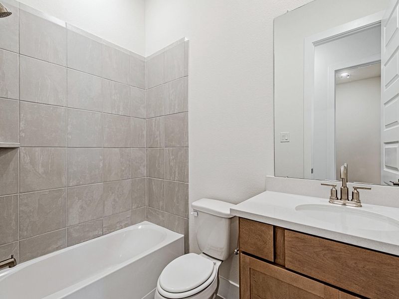 Full bathroom with tub/shower combo and vanity.