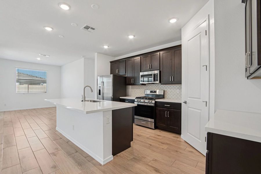 Kitchen and dining. Not actual home, finishes may vary by community.