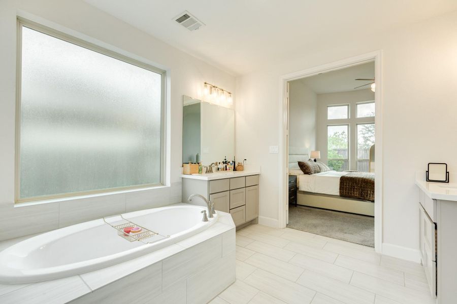 Double doors lead into the primary bath, creating an effortless and open flow from the bedroom. Double doors lead into the primary bath, creating an effortless and open flow from the bedroom.