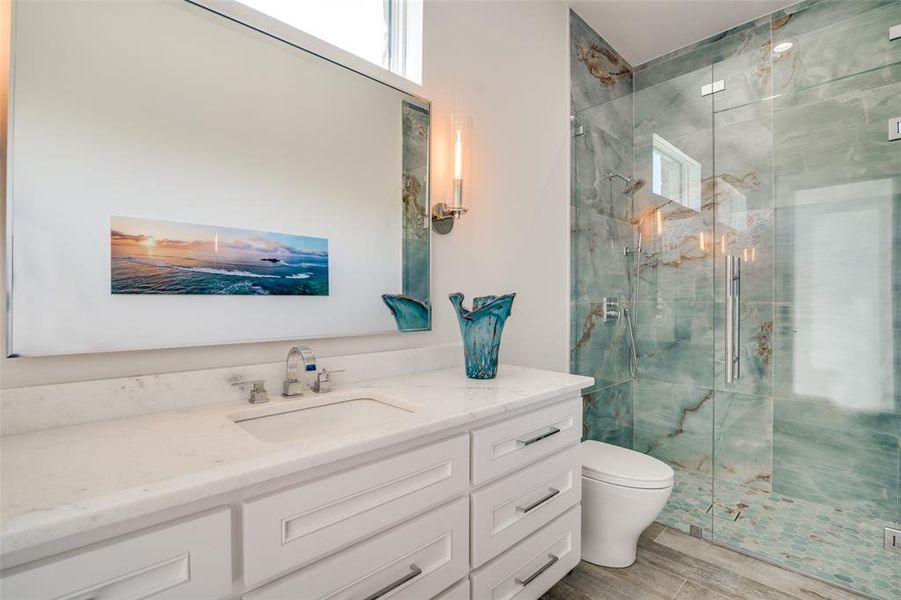 Outdoor Pool Bathroom with toilet, vanity, and an enclosed shower