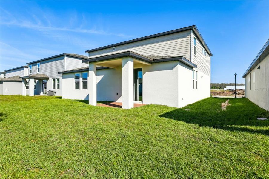 Exterior details and patio area of a home in The Meadow at Crossprairie, St. Cloud (Image 3).