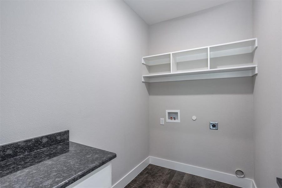 Laundry room featuring electric dryer hookup, dark wood finished floors, hookup for a washing machine, and hookup for a gas dryer Laundry room featuring electric dryer hookup, dark wood finished floors, hookup for a washing machine, and hookup for a gas dryer