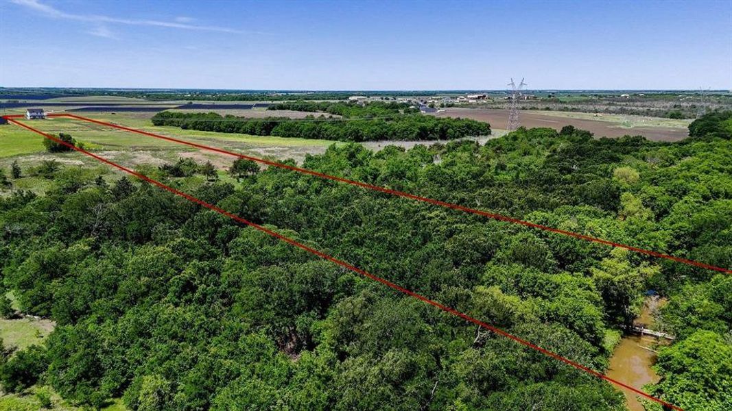 Expansive acreage featuring dense tree cover and open grassy areas