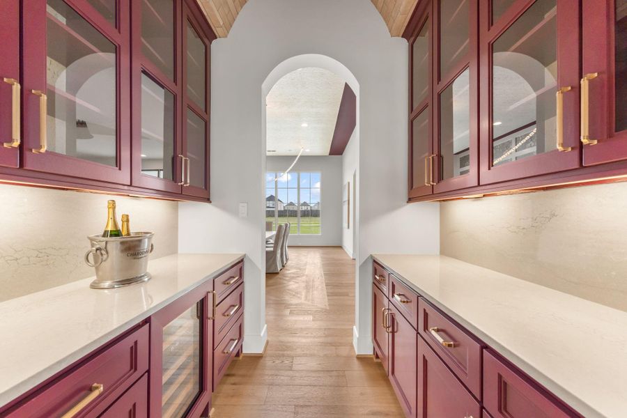 Dramatic butler's pantry with brick barrel ceiling and rich crimson cabinets. Dramatic butler's pantry with brick barrel ceiling and rich crimson cabinets.