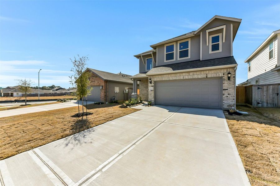 Front exterior of a new home in Colony at Pinehurst, Pinehurst, TX, highlighting curb appeal (Image 2).